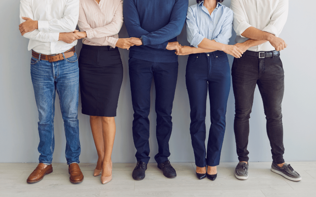 Co-workers holding hands as a team.